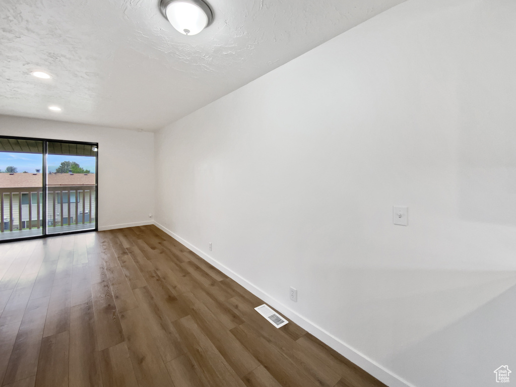 Unfurnished room featuring baseboards and wood finished floors