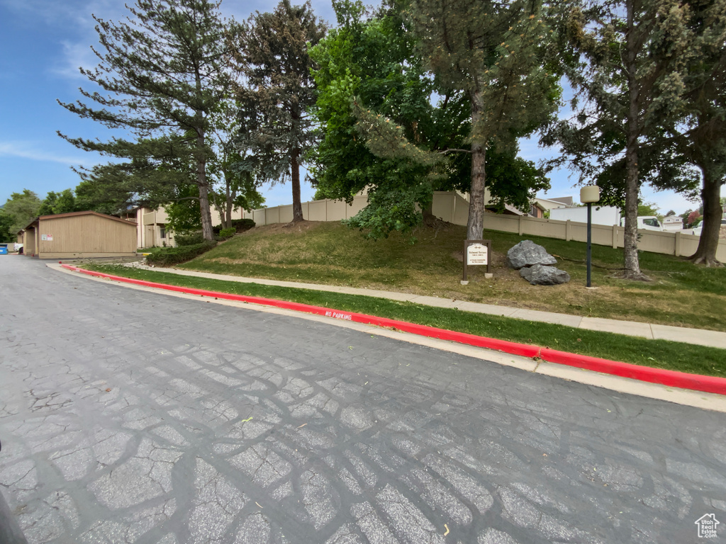 View of road with sidewalks, curbs, and street lights
