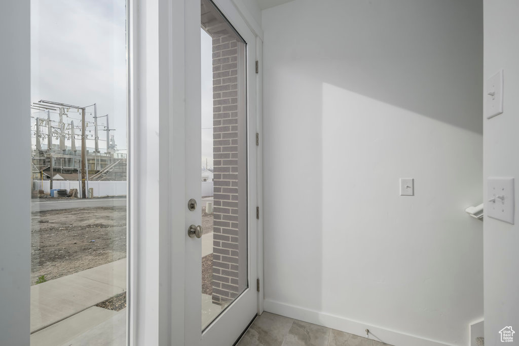 Doorway to outside featuring baseboards