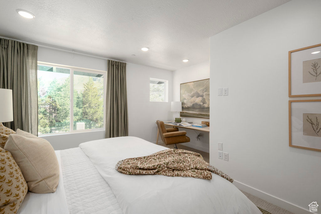 Bedroom featuring multiple windows, carpet floors, and recessed lighting