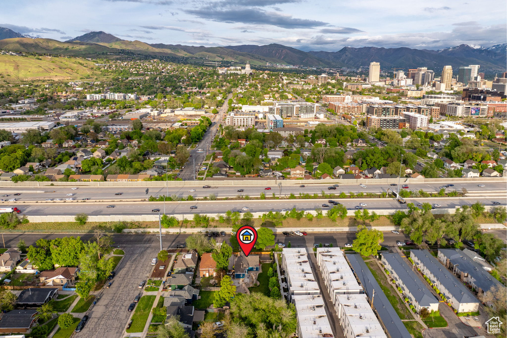 Aerial view of property\\\'s location featuring a mountain backdrop and nearby urban area