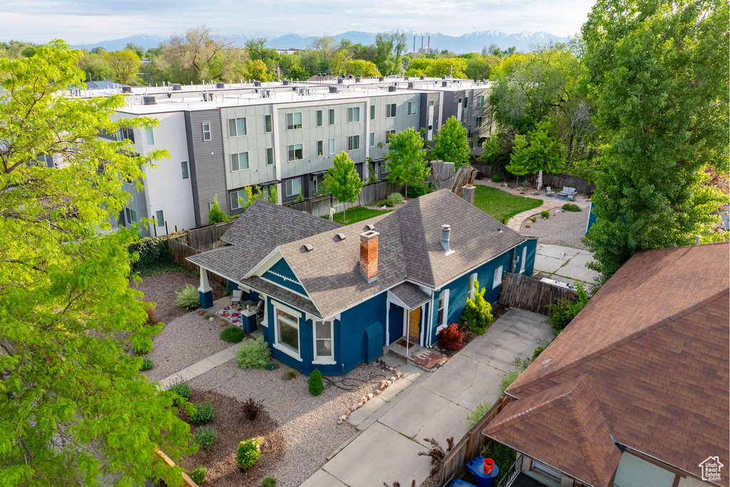 Aerial view of property and surrounding area featuring mountains