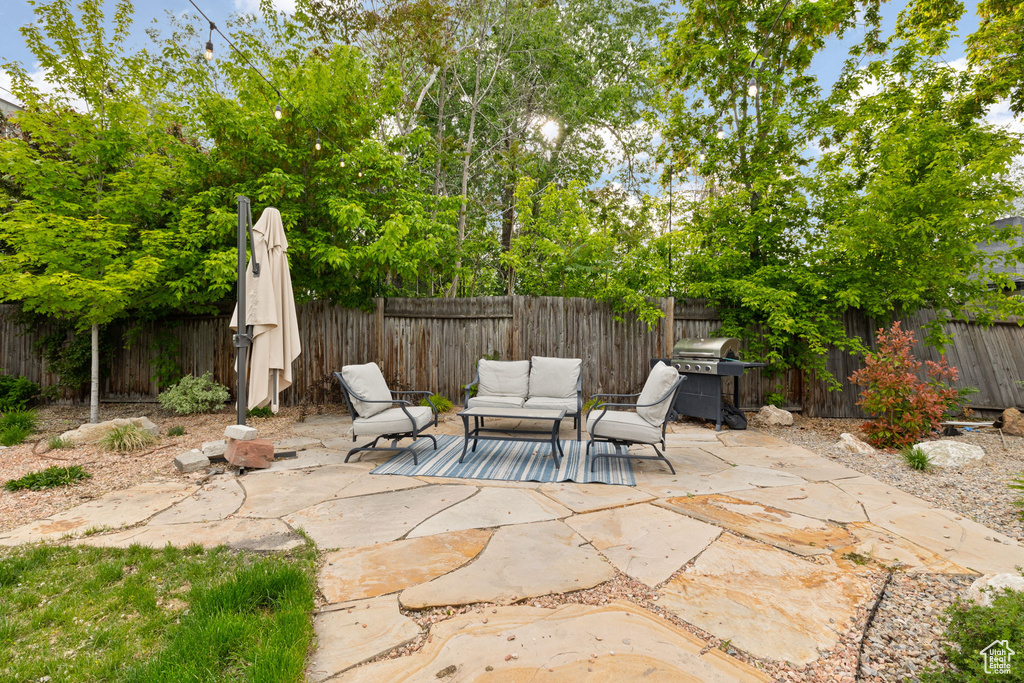 View of patio featuring a grill, a fenced backyard, and outdoor lounge area