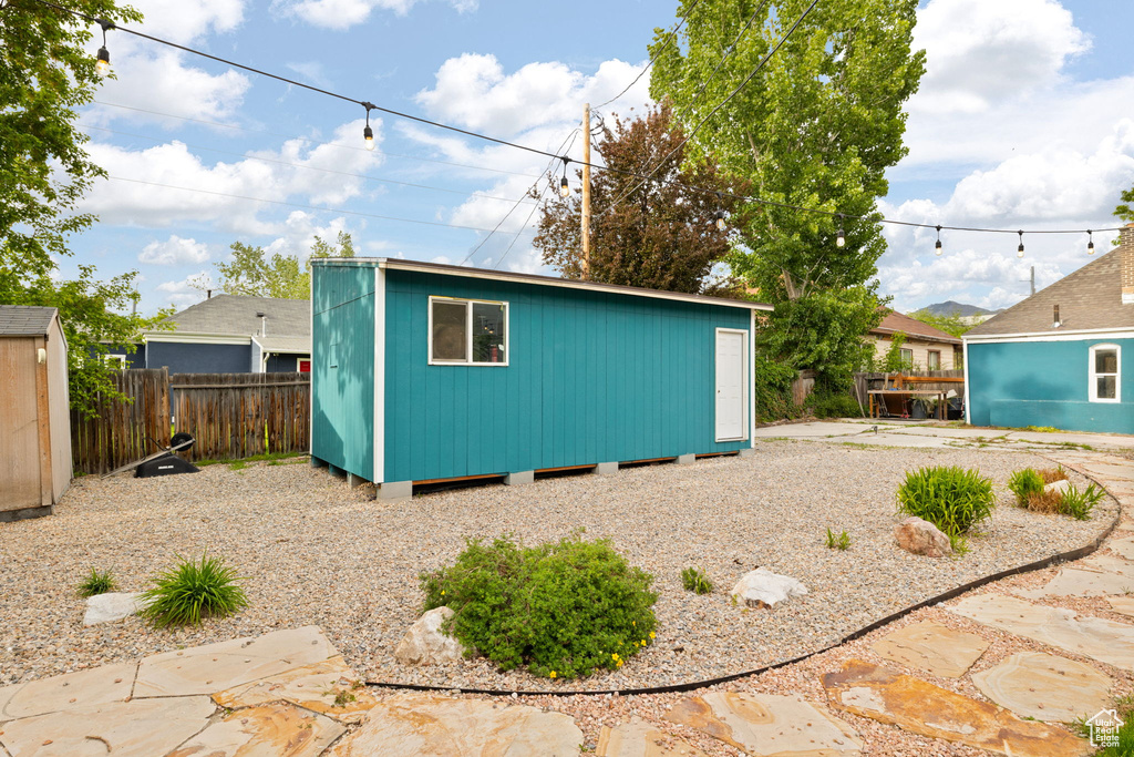 View of outbuilding featuring fence and an outdoor structure