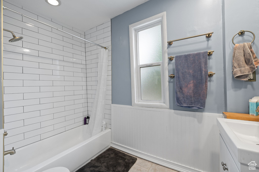 Bathroom with wainscoting, shower / tub combo, vanity, and tile patterned flooring