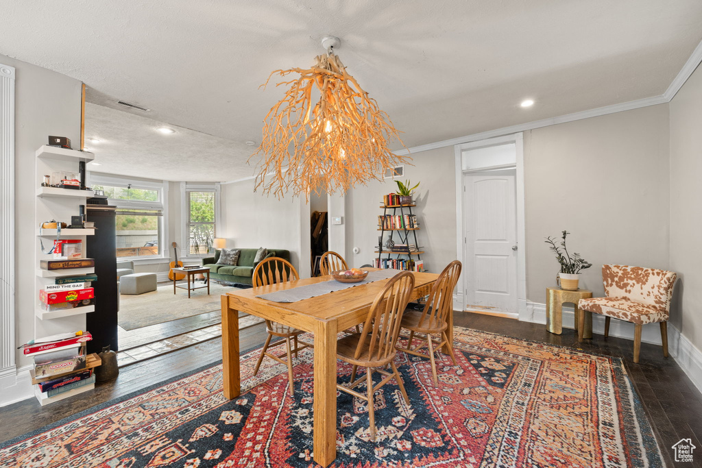 Dining space featuring hardwood / wood-style flooring, baseboards, recessed lighting, and ornamental molding