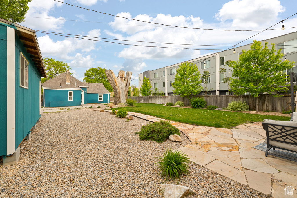 View of yard with a patio and a residential view