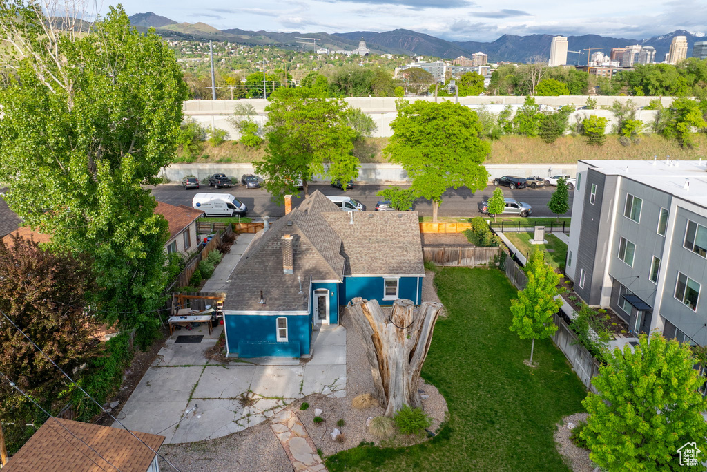 Aerial view of property and surrounding area featuring a mountain backdrop