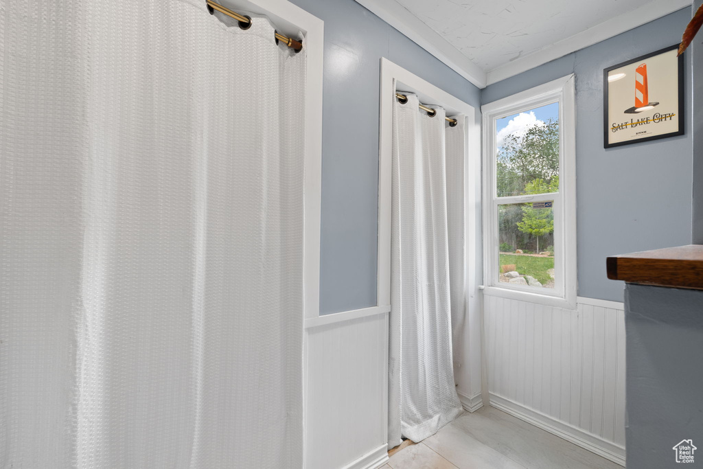 Entryway featuring a wainscoted wall