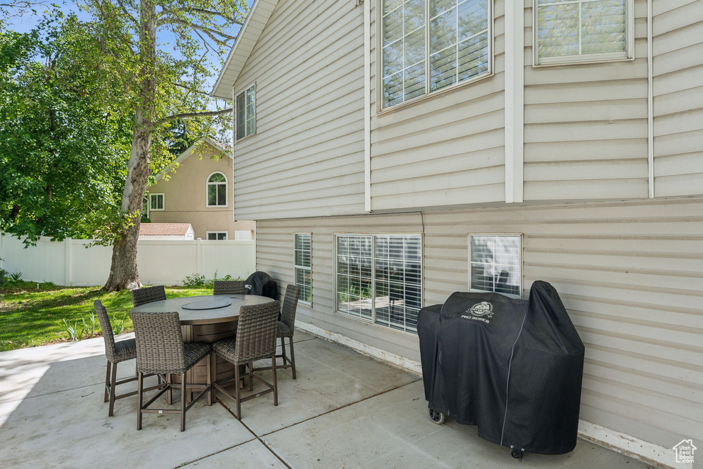View of patio with fence and outdoor dining area