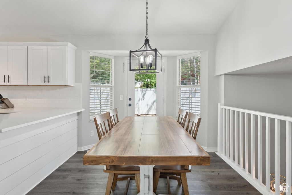 Dining room featuring a chandelier and dark wood-style floors