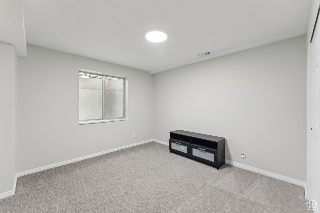 Empty room featuring carpet flooring and baseboards