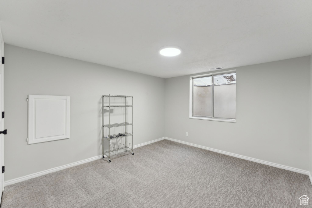 Empty room with carpet floors and baseboards