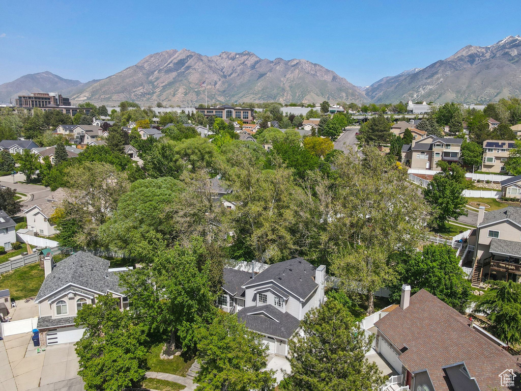 Aerial overview of property's location featuring nearby suburban area and a mountainous background