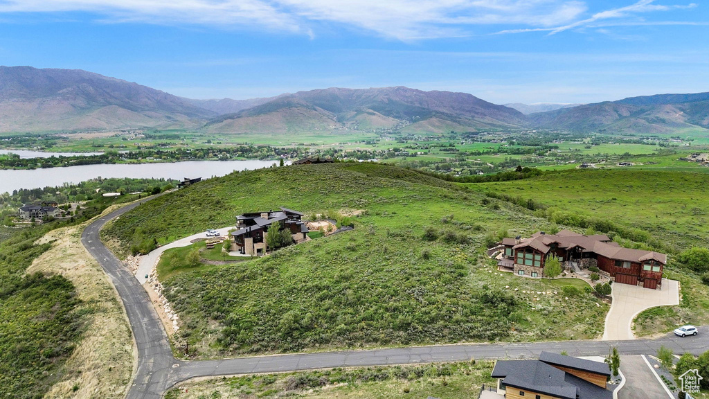 View from above of property with a water and mountain view