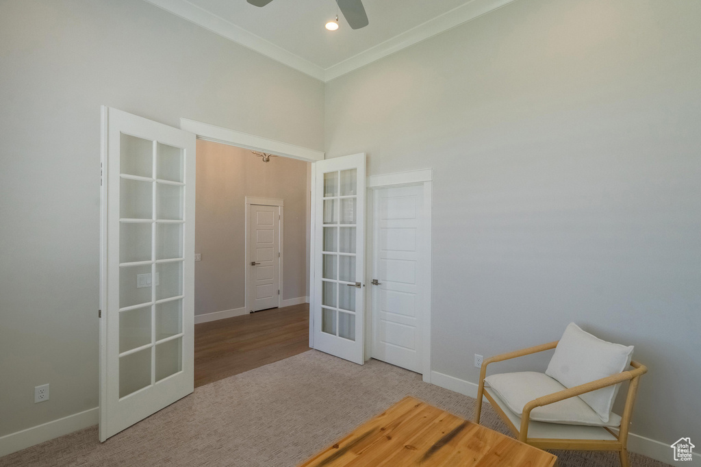 Living area with french doors, baseboards, carpet floors, a ceiling fan, and ornamental molding