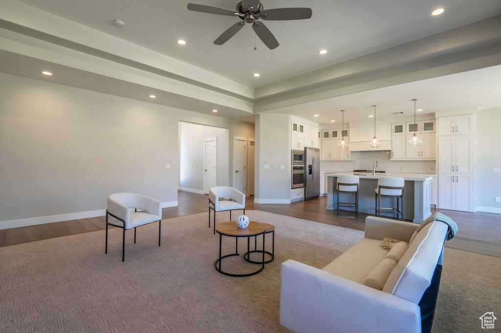 Living room featuring recessed lighting, dark wood-style flooring, baseboards, and ceiling fan