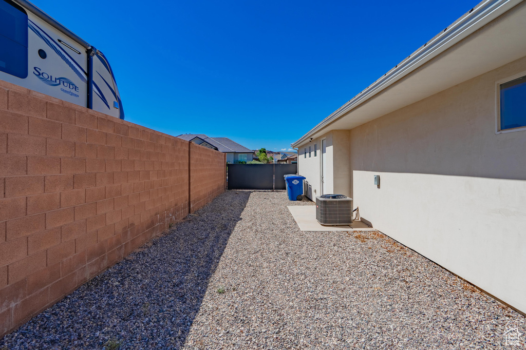 Fenced backyard with central air condition unit