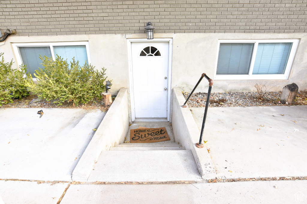 Entrance to property featuring brick siding and stucco siding