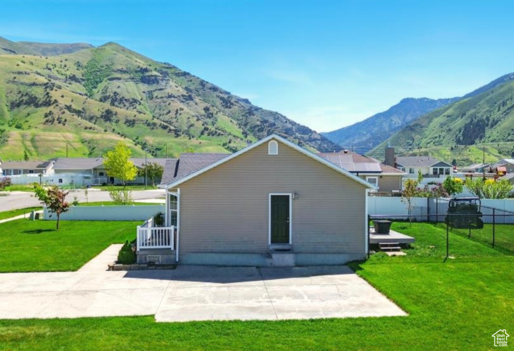 Back of property with a patio area and a mountain view
