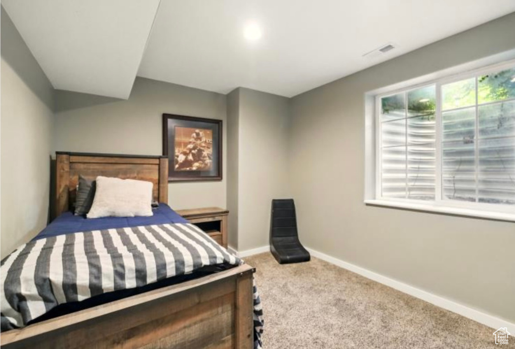 Bedroom with carpet flooring and baseboards