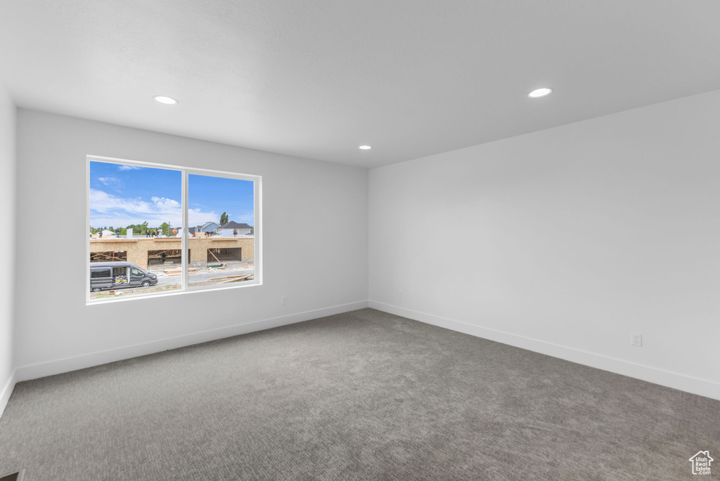 Unfurnished room featuring carpet flooring, recessed lighting, and baseboards