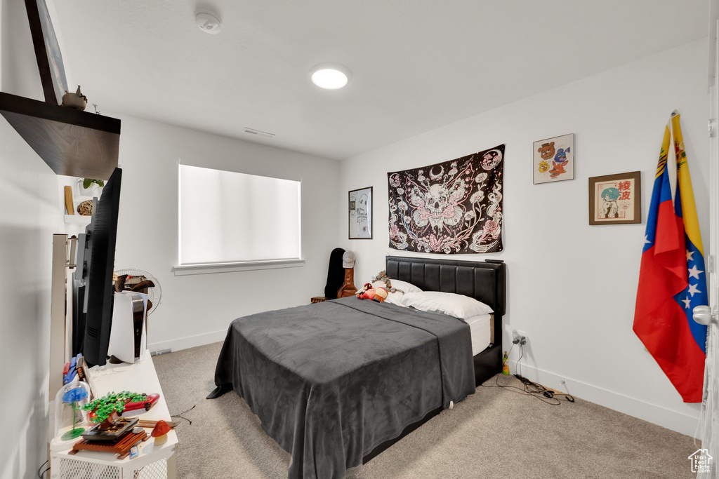 Carpeted bedroom featuring baseboards