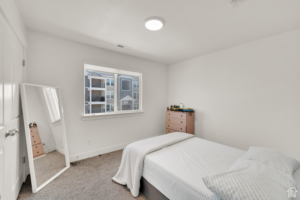 Carpeted bedroom featuring baseboards