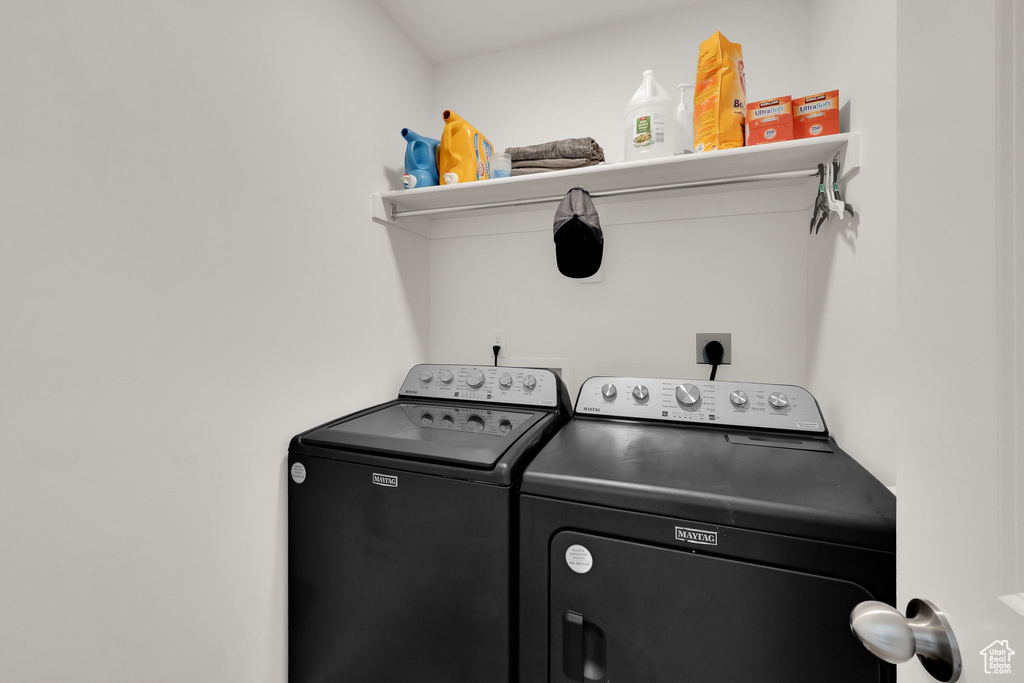 Laundry room with washing machine and clothes dryer