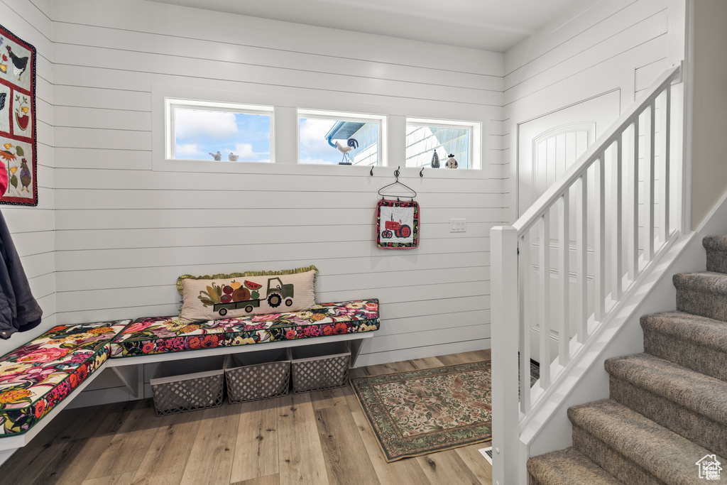 Mudroom featuring wood walls and wood finished floors