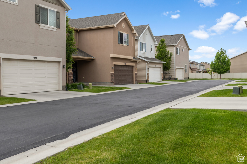 View of asphalt street featuring a residential view