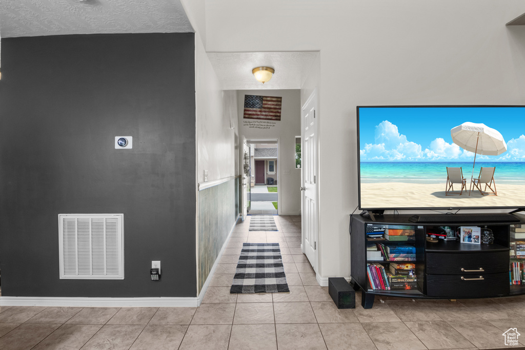 Corridor with tile patterned flooring and baseboards
