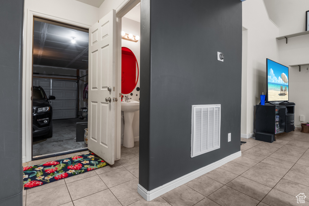 Hall featuring tile patterned floors