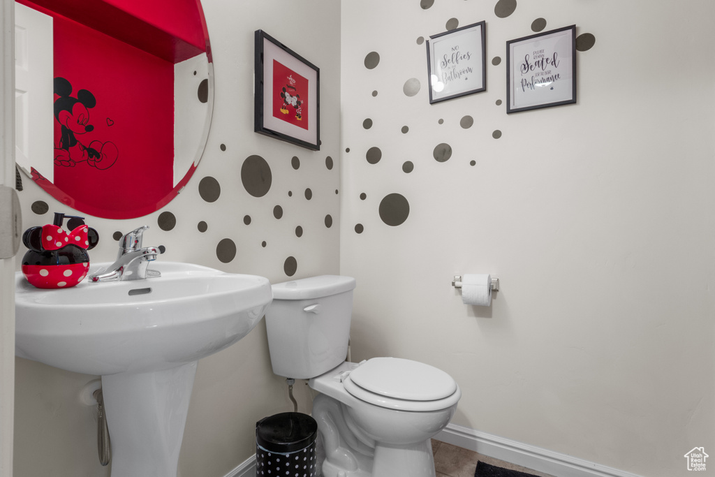 Half bathroom featuring toilet and baseboards
