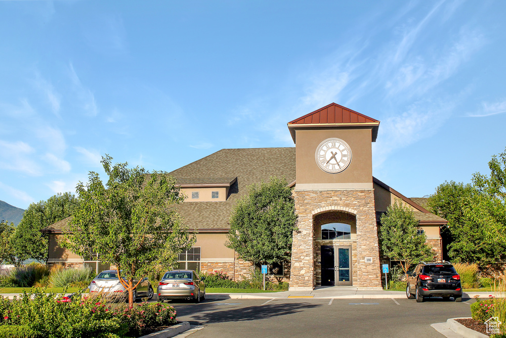 View of property featuring uncovered parking