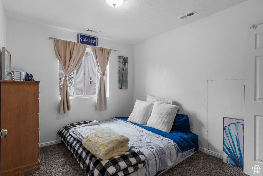 Carpeted bedroom with baseboards