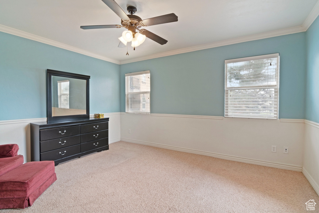Living area with carpet flooring, ornamental molding, ceiling fan, and baseboards