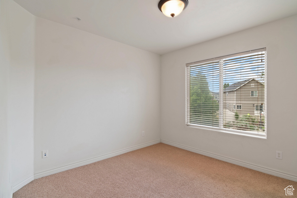 Unfurnished room with carpet floors and baseboards