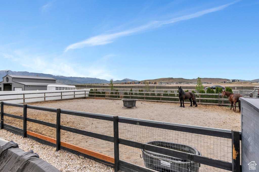 View of yard featuring an enclosed horse arena, a mountain view, and a view of countryside