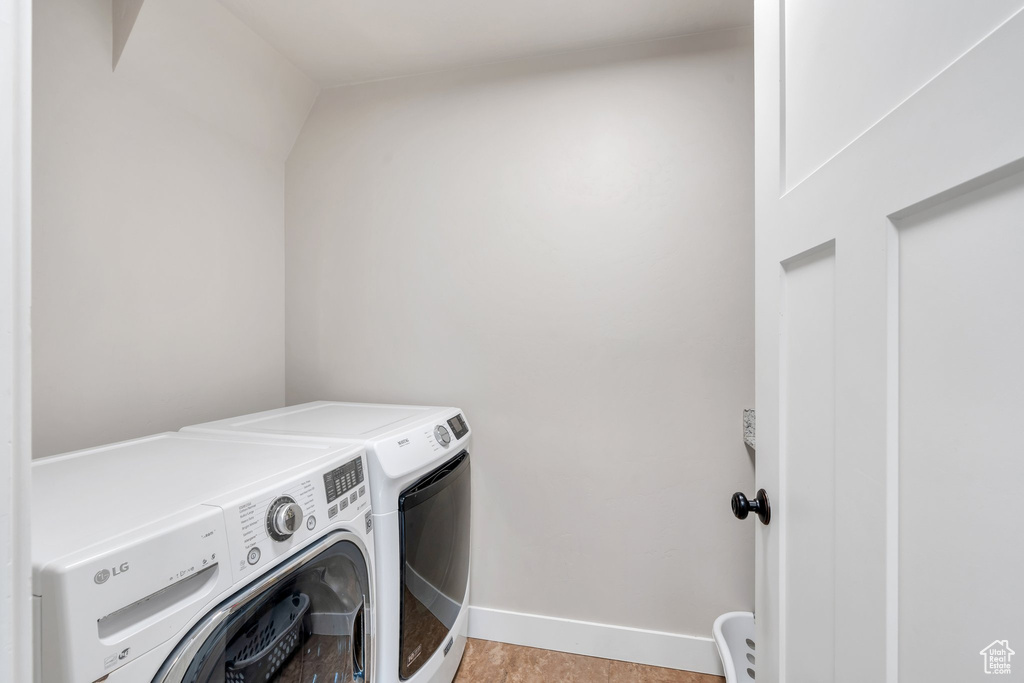 Laundry room featuring independent washer and dryer and baseboards