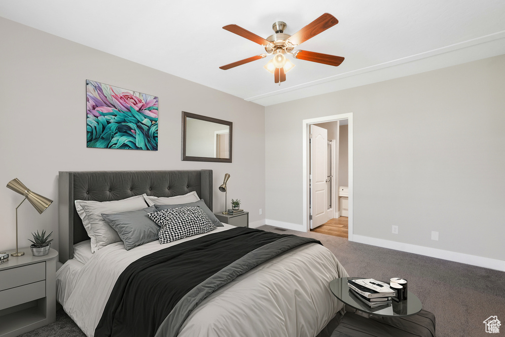 Bedroom with carpet floors, baseboards, a ceiling fan, and ensuite bath