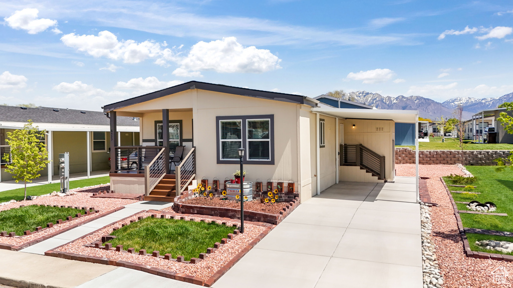 View of front facade with a mountain view and covered porch