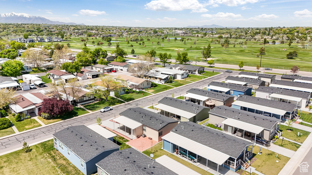 Aerial view of residential area with a local golf course and mountains