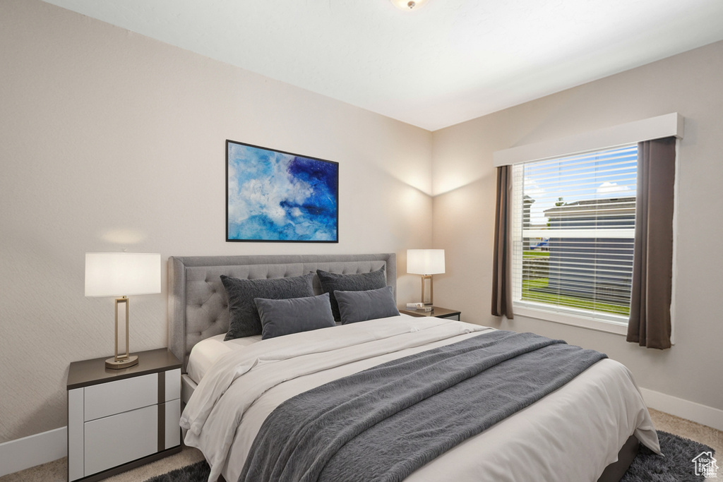 Carpeted bedroom featuring baseboards