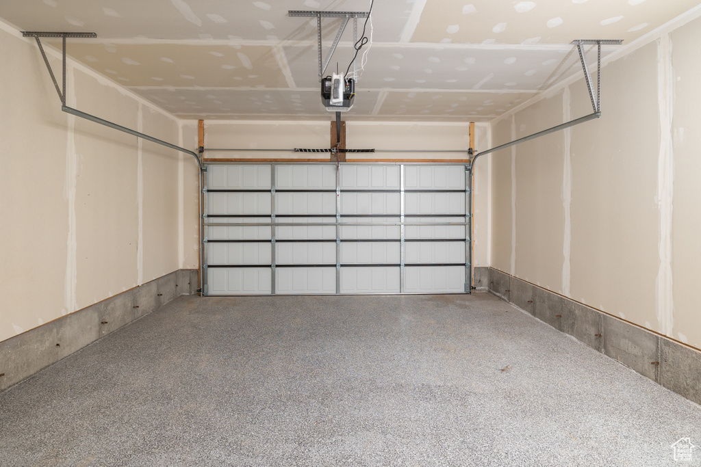 Garage featuring a garage door opener