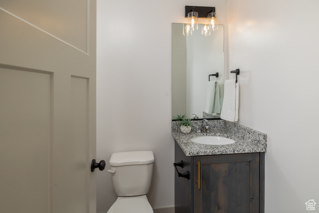 Half bathroom featuring toilet and vanity