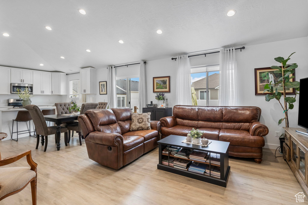 Living area featuring plenty of natural light, recessed lighting, and light wood-style floors