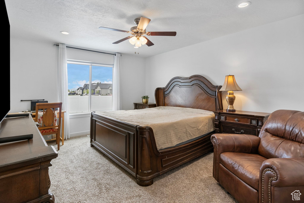 Bedroom with light carpet, recessed lighting, and a ceiling fan