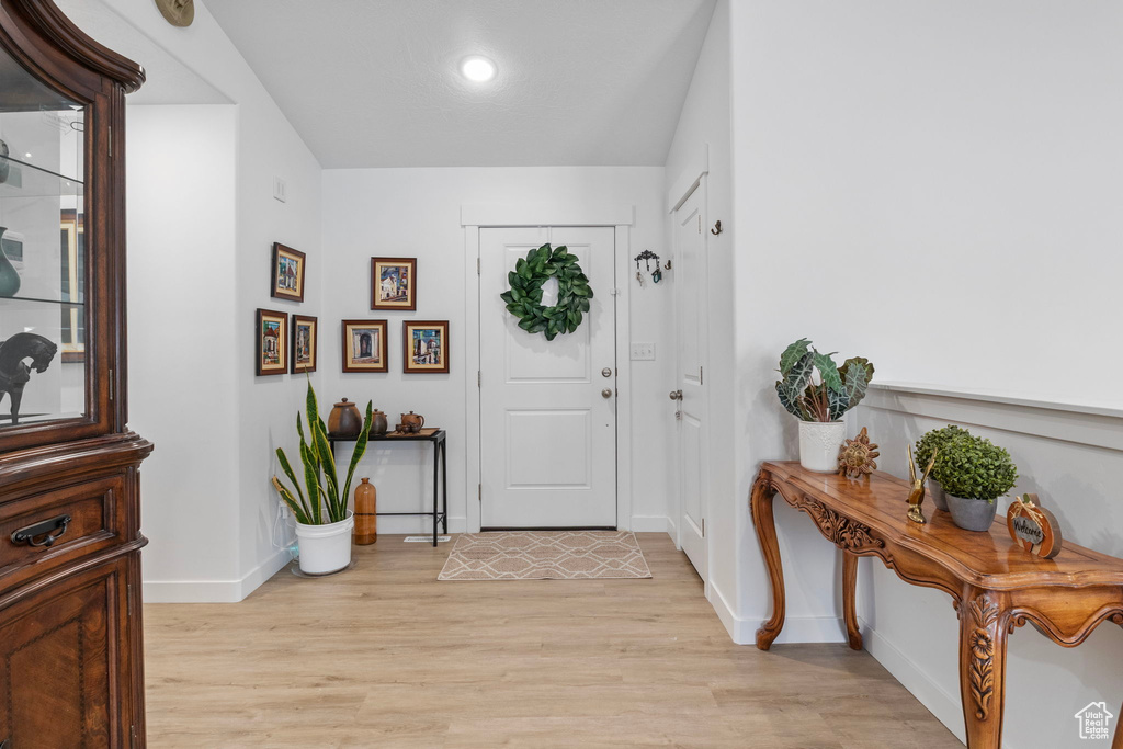 Foyer featuring light wood-type flooring and baseboards