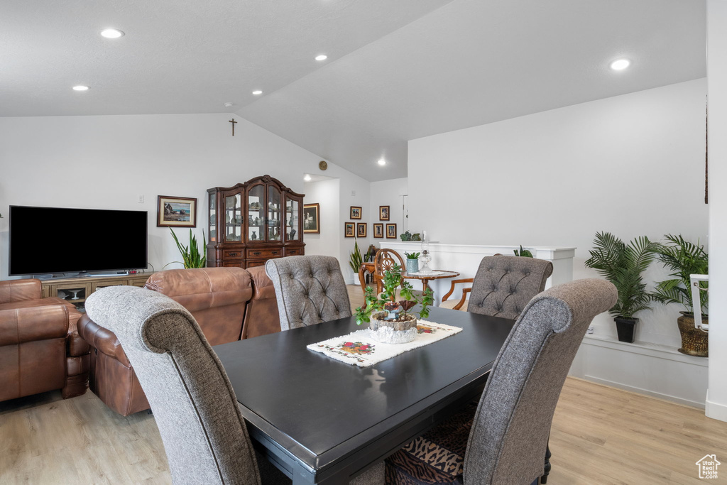 Dining area featuring light wood-style flooring, lofted ceiling, and recessed lighting